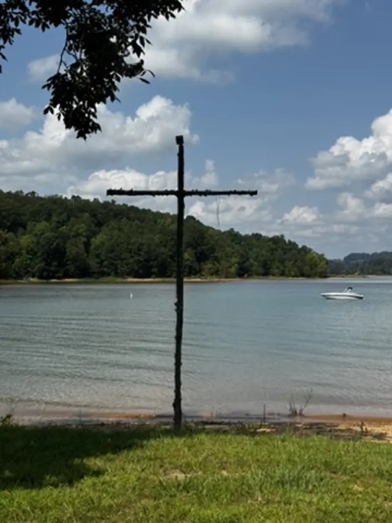 Wooden cross on the shore of Norris Lake at camp