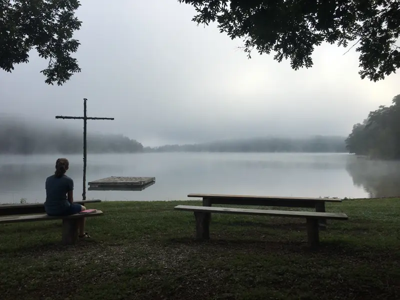 Misty morning at the lakeside cross and benches at Galilee Bible Camp