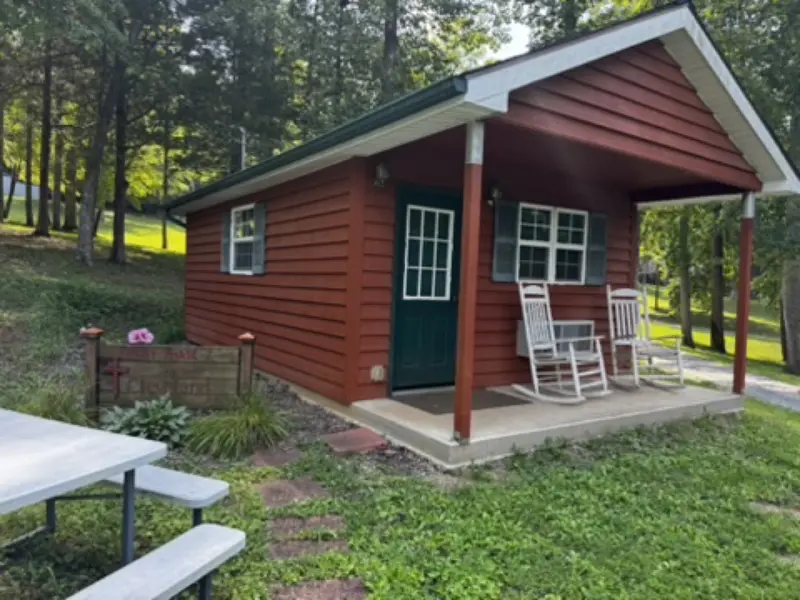 Small red cabin with rocking chairs